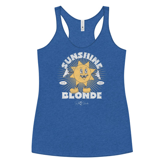 royal blue women’s racerback tank with a retro cartoon-style yellow sun character, smiling with open arms, surrounded by radiant sunbeams. The text reads ‘Sunshine Blonde’ in bold vintage Belzebuth lettering, with small details including ‘ESTD 1994’ and the RedBlonde signature logo beneath."