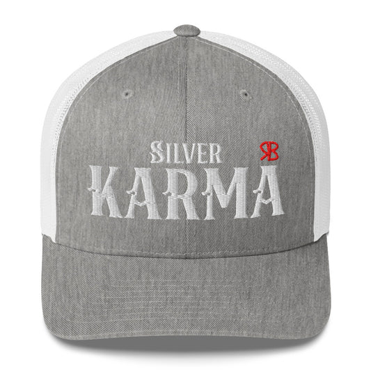 light grey / white retro trucker cap with mesh back. The front features bold white embroidered text reading "SILVER KARMA" with a small red RB logo to the right.