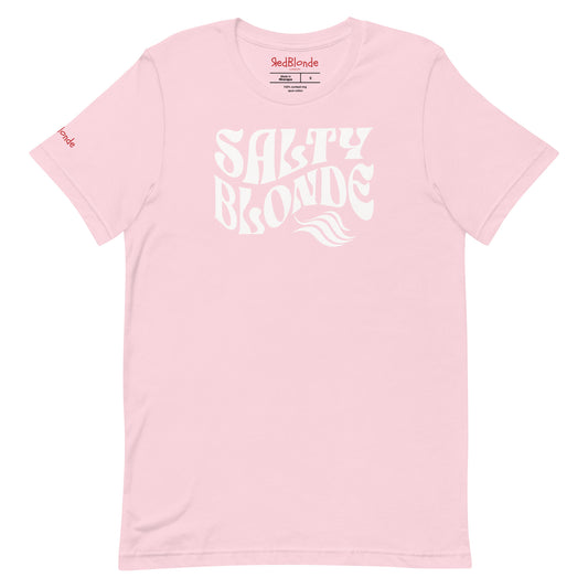 flatlay of soft pink classic unisex graphic t-shirt with the slogan 'Salty Blonde' in Solino Display white retro 70s wavy font. Branded RedBlonde in red on inside neck and right sleeve