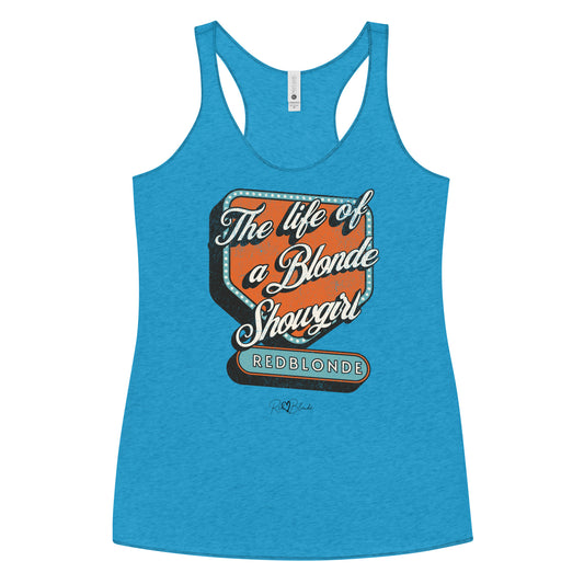 Vintage turquoise blue racerback tank t-shirt with bold retro-style graphic text reading 'The life of a Blonde Showgirl' in white script over an orange and turquoise marquee design. The word 'RedBlonde' is displayed in turquoise block letters at the bottom, with subtle worn details giving the shirt a distressed, retro look." 