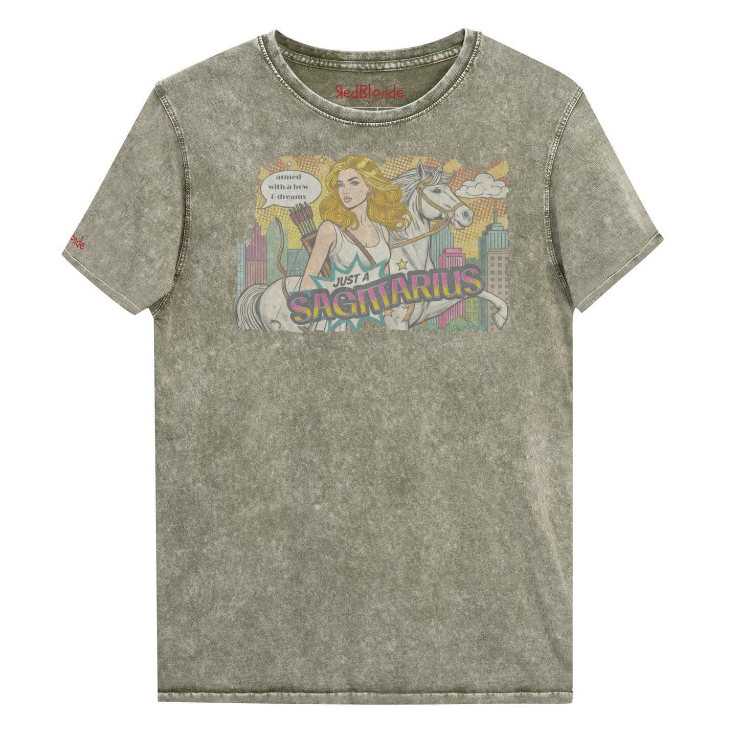 Flatlay of a unisex army green denim wash vintage t-shirt with a retro pop-art Blonde Sagittarius graphic featuring a blonde woman, with bow & arrows, white stallion, and a city backdrop, captioned ‘Just a Sagittarius, armed with a bow & dreams'. Branded RedBlonde on the inside neck and right sleeve