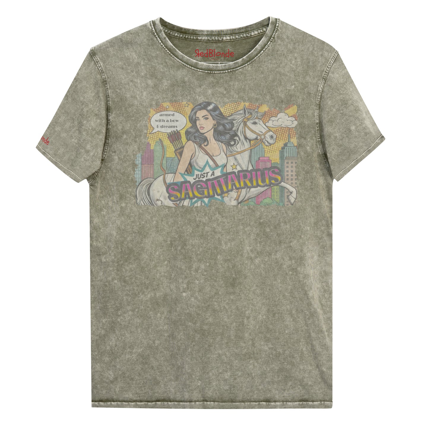 Flatlay of a unisex army green denim wash vintage t-shirt with a retro pop-art Sagittarius graphic featuring a black haired woman, with bow & arrows, white stallion, and a city backdrop, captioned ‘Just a Sagittarius, armed with a bow & dreams'. Branded RedBlonde on the inside neck and right sleeve