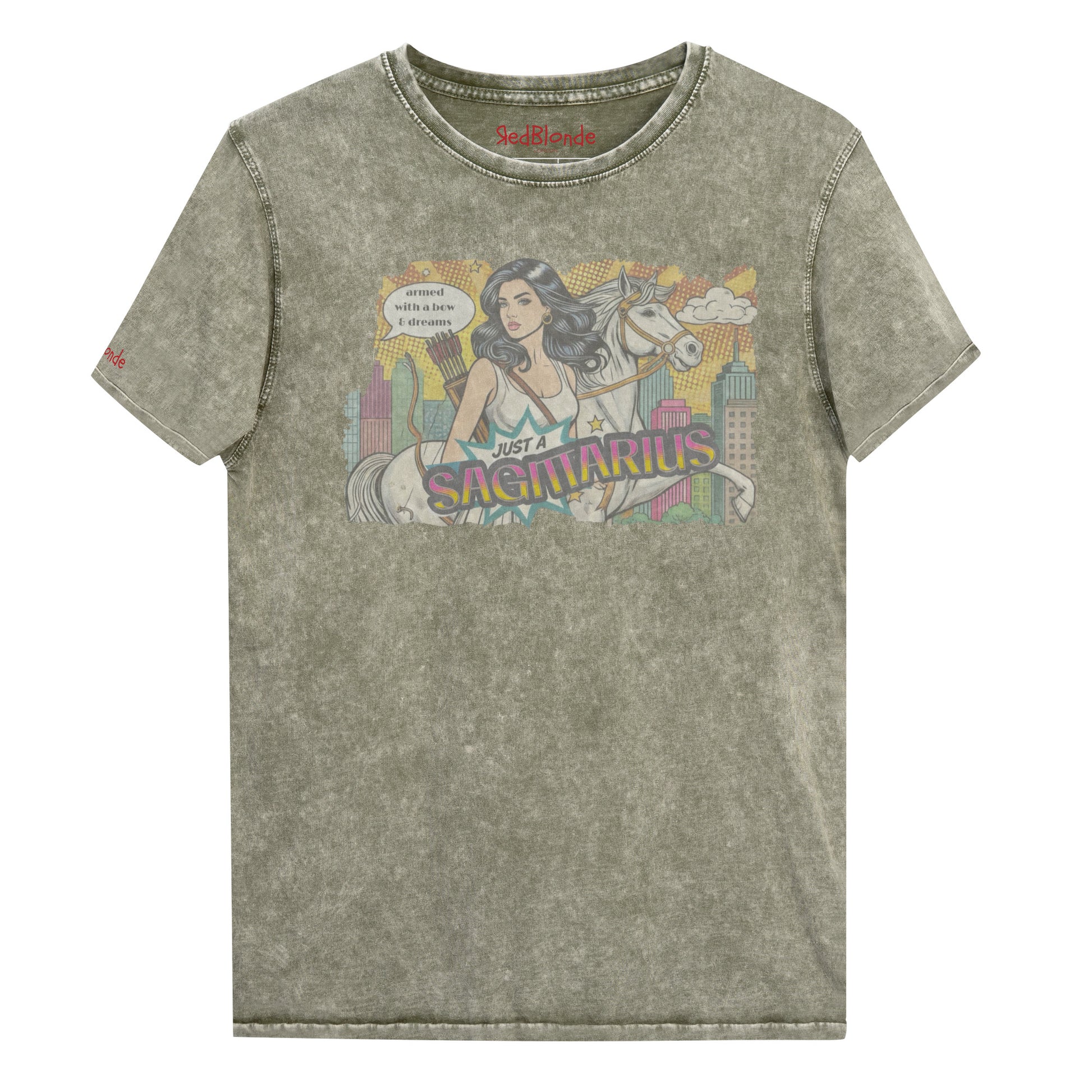 Flatlay of a unisex army green denim wash vintage t-shirt with a retro pop-art Sagittarius graphic featuring a black haired woman, with bow & arrows, white stallion, and a city backdrop, captioned ‘Just a Sagittarius, armed with a bow & dreams'. Branded RedBlonde on the inside neck and right sleeve