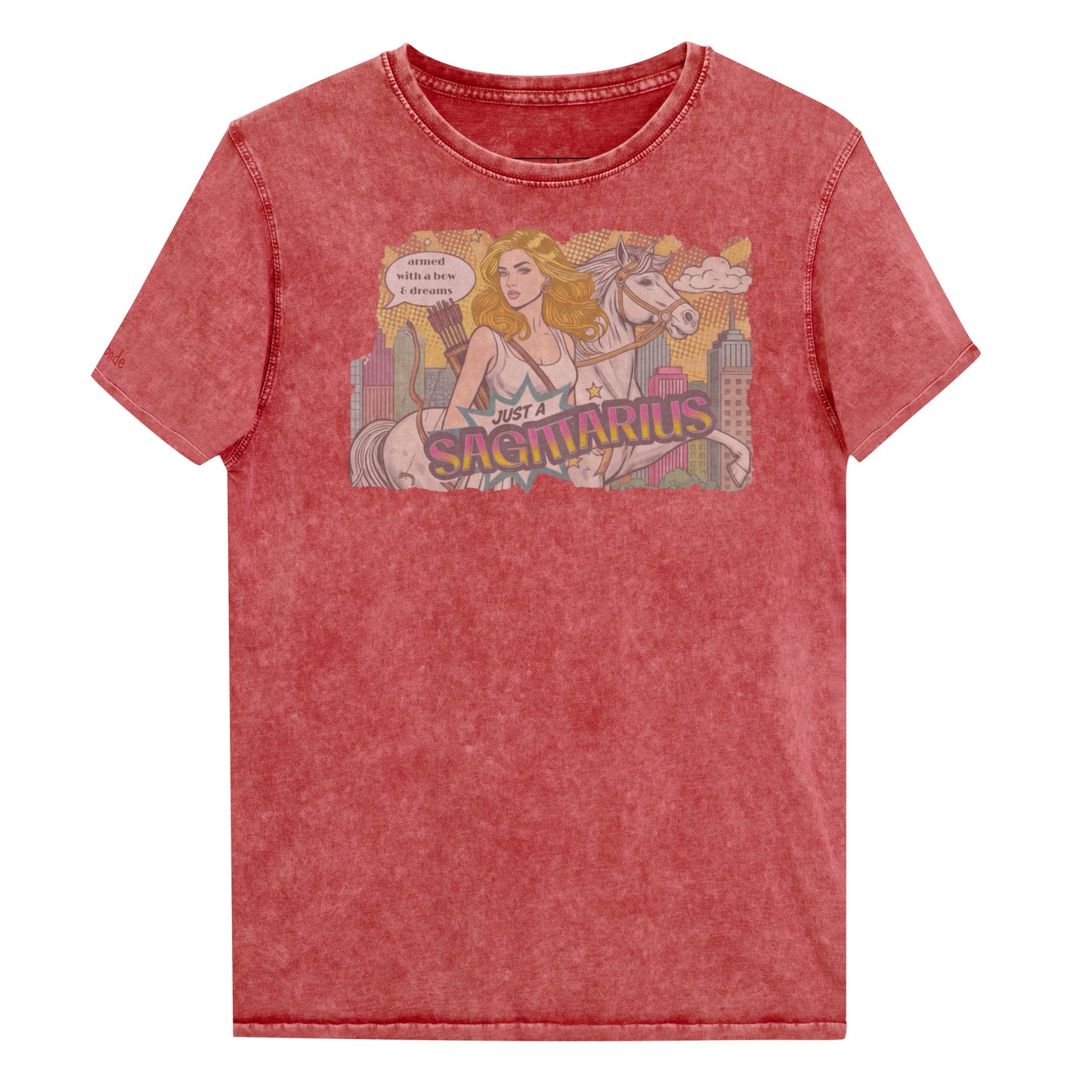 Flatlay of a unisex garnet red denim wash vintage t-shirt with a retro pop-art Blonde Sagittarius graphic featuring a blonde woman, with bow & arrows, white stallion, and a city backdrop, captioned ‘Just a Sagittarius, armed with a bow & dreams'. Branded RedBlonde on the inside neck and right sleeve