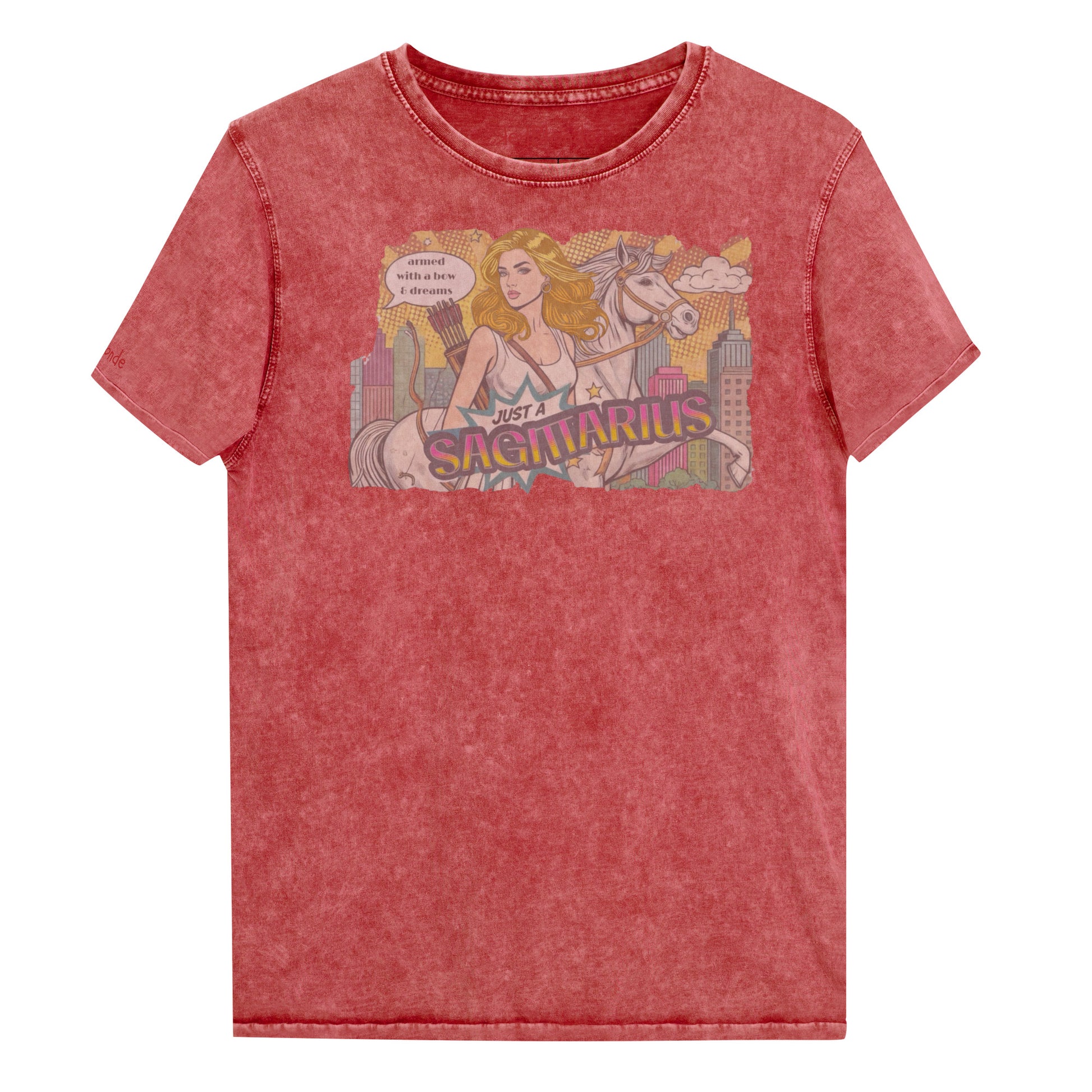 Flatlay of a unisex garnet red denim wash vintage t-shirt with a retro pop-art Blonde Sagittarius graphic featuring a blonde woman, with bow & arrows, white stallion, and a city backdrop, captioned ‘Just a Sagittarius, armed with a bow & dreams'. Branded RedBlonde on the inside neck and right sleeve