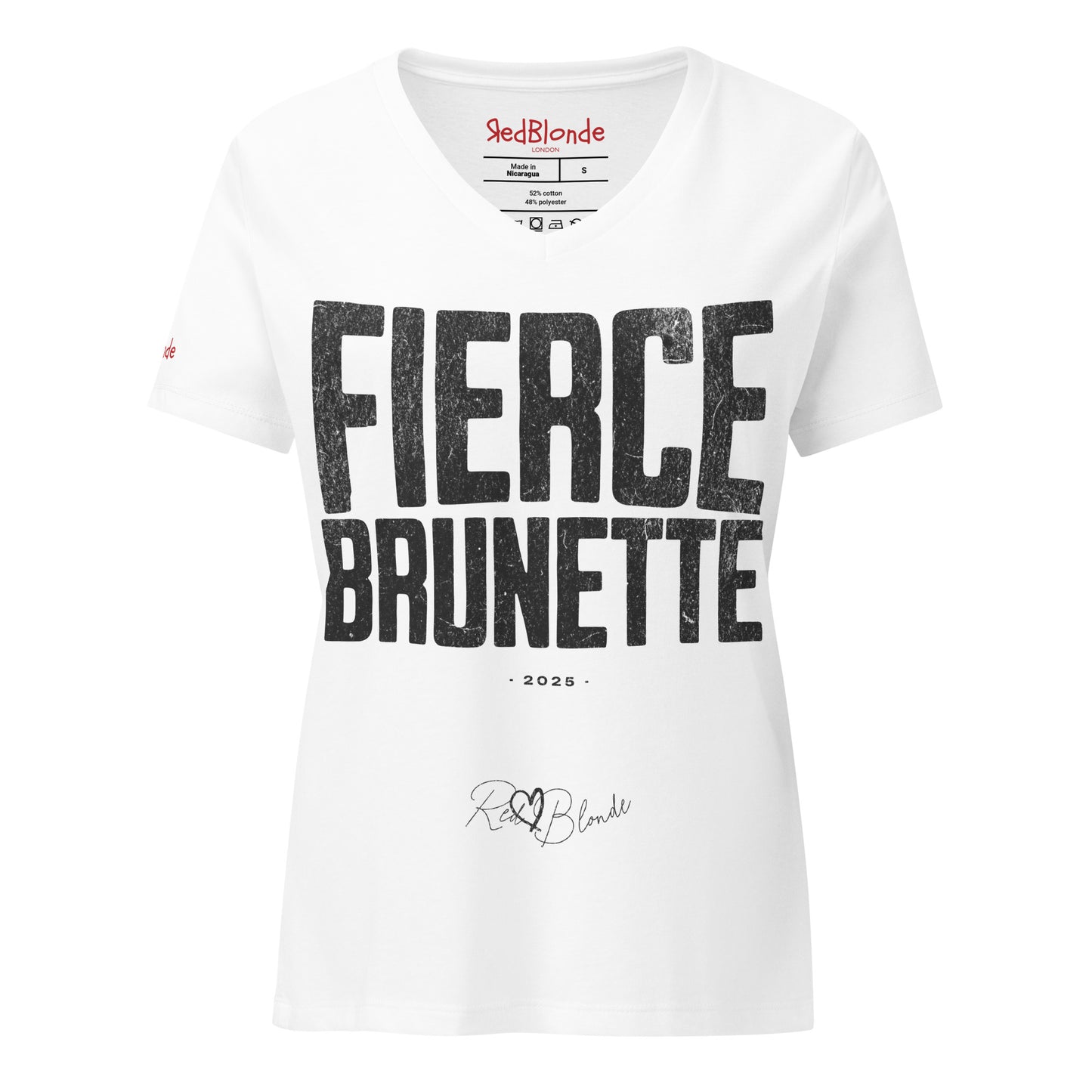 white women’s V-neck T-shirt featuring the bold black distressed text “FIERCE BRUNETTE” in large North Road capital letters across the chest. Beneath the text, the year “2025” is printed in small type, with the “RedBlonde” brand signature logo below it. The inner collar shows the “RedBlonde” brand name in red along with sizing and care details, and “RedBlonde” is also printed in small red letters on the right sleeve.
