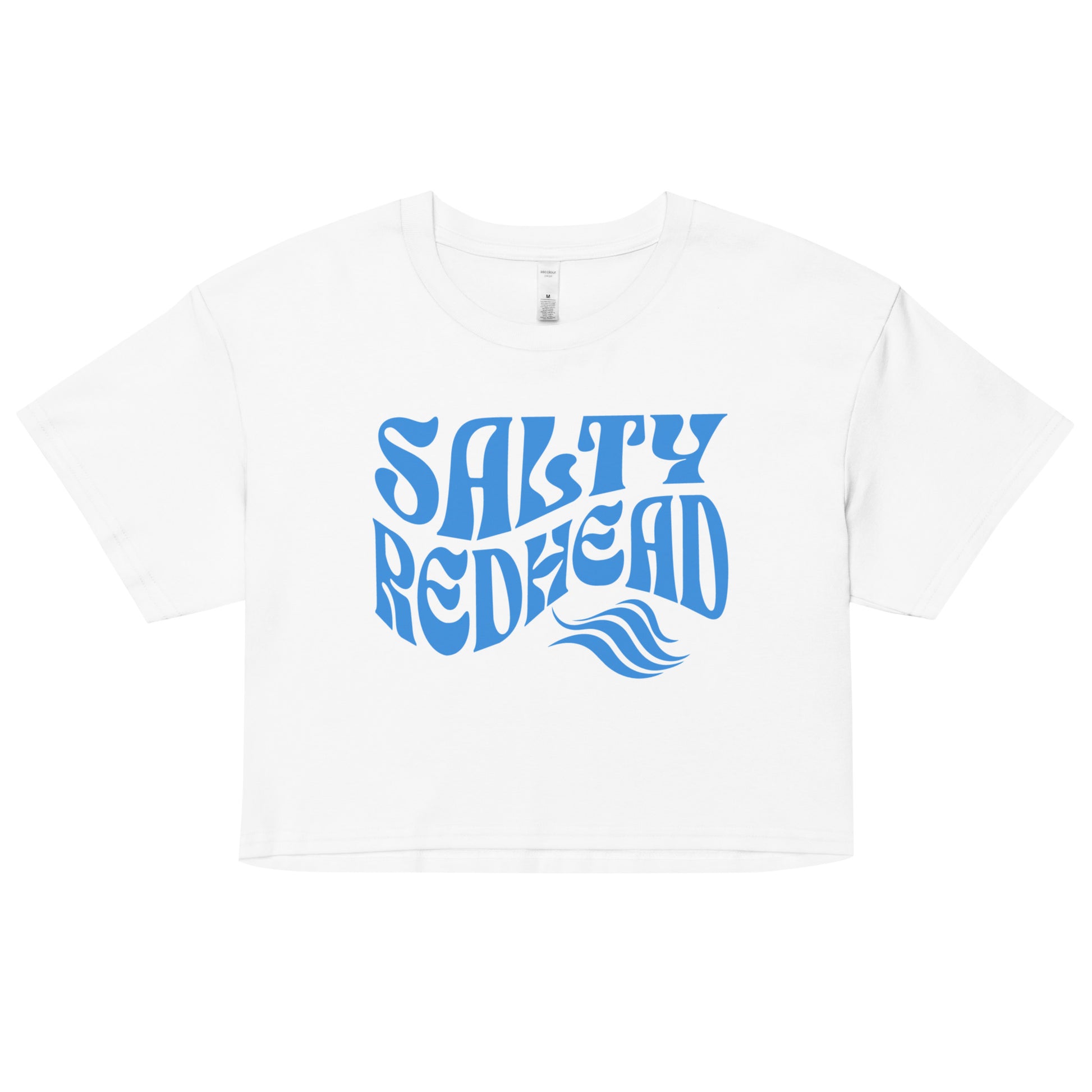 Flatlay of a white loose woman's crop top t-shirt with the words ‘Salty Redhead’ in retro 70s text in blue. branded redblonde on inside neck and right shoulder