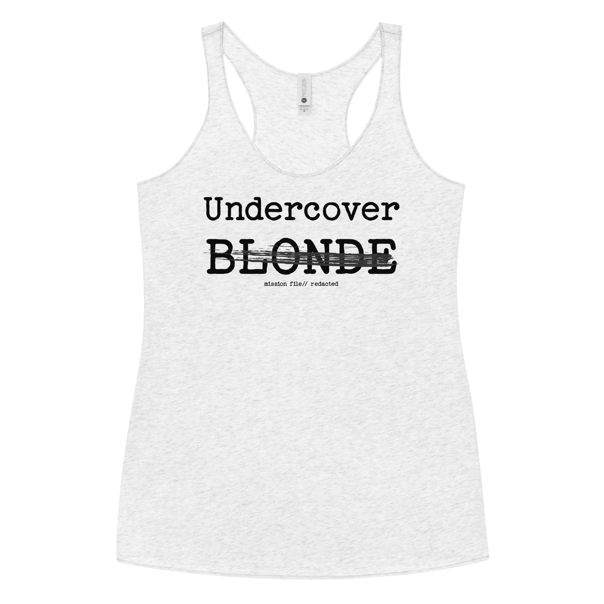 A white racerback tank featuring a bold black text reading “Undercover BLONDE” with “BLONDE” partially struck through by a horizontal black bar. Beneath it, smaller text says “mission file // redacted” along with a subtle RedBlonde logo. Branded RedBlonde London in red on the reverse