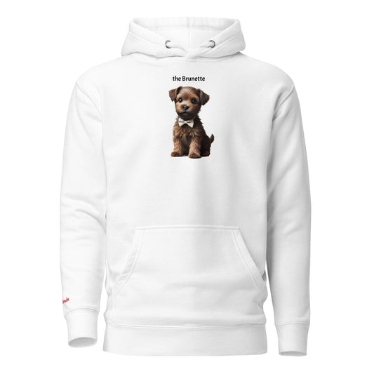 Flatlay of white relaxed fit unisex hoodie with a cute graphic of a Brunette puppy wearing a bow-tie and the words 'the Brunette' linking to Brunette hair. Branded RedBlonde in red on inside neck and right cuff