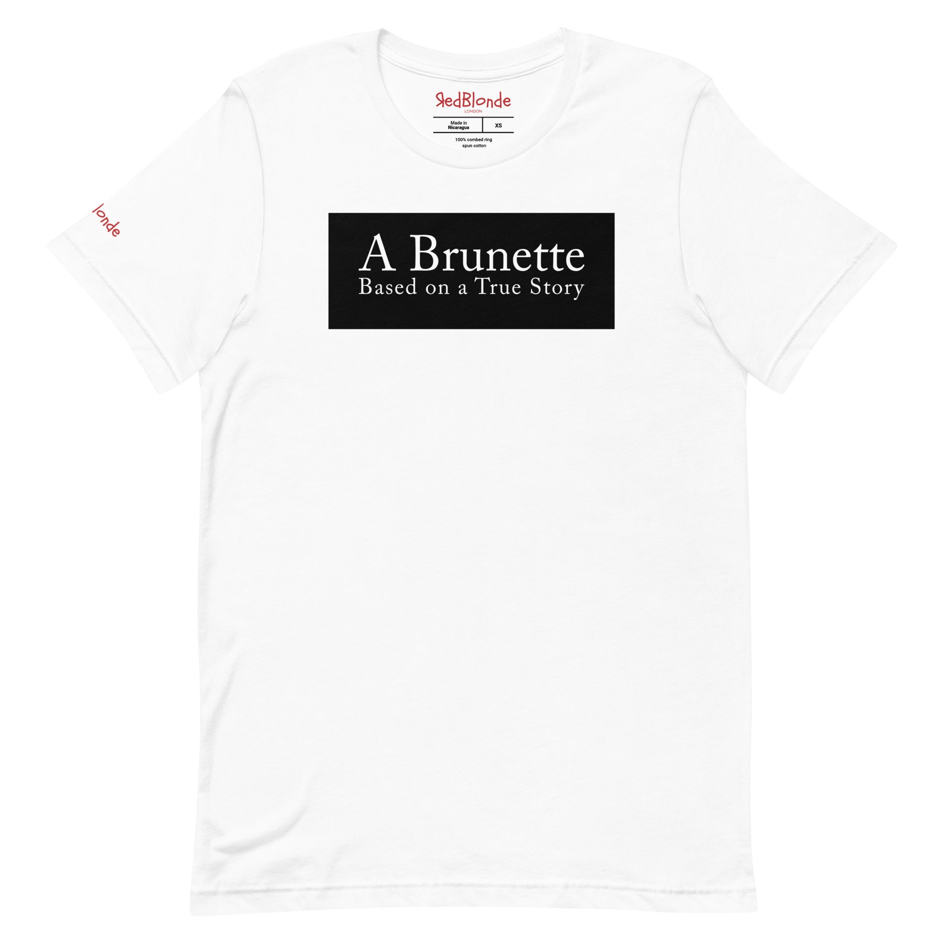 flatlay of a white unisex relaxed fit t-shirt with the slogan 'A Brunette. Based on a True Story' in white adobe caslon font in a black box graphic. Branded RedBlonde London in red on inside neck and right sleeve 