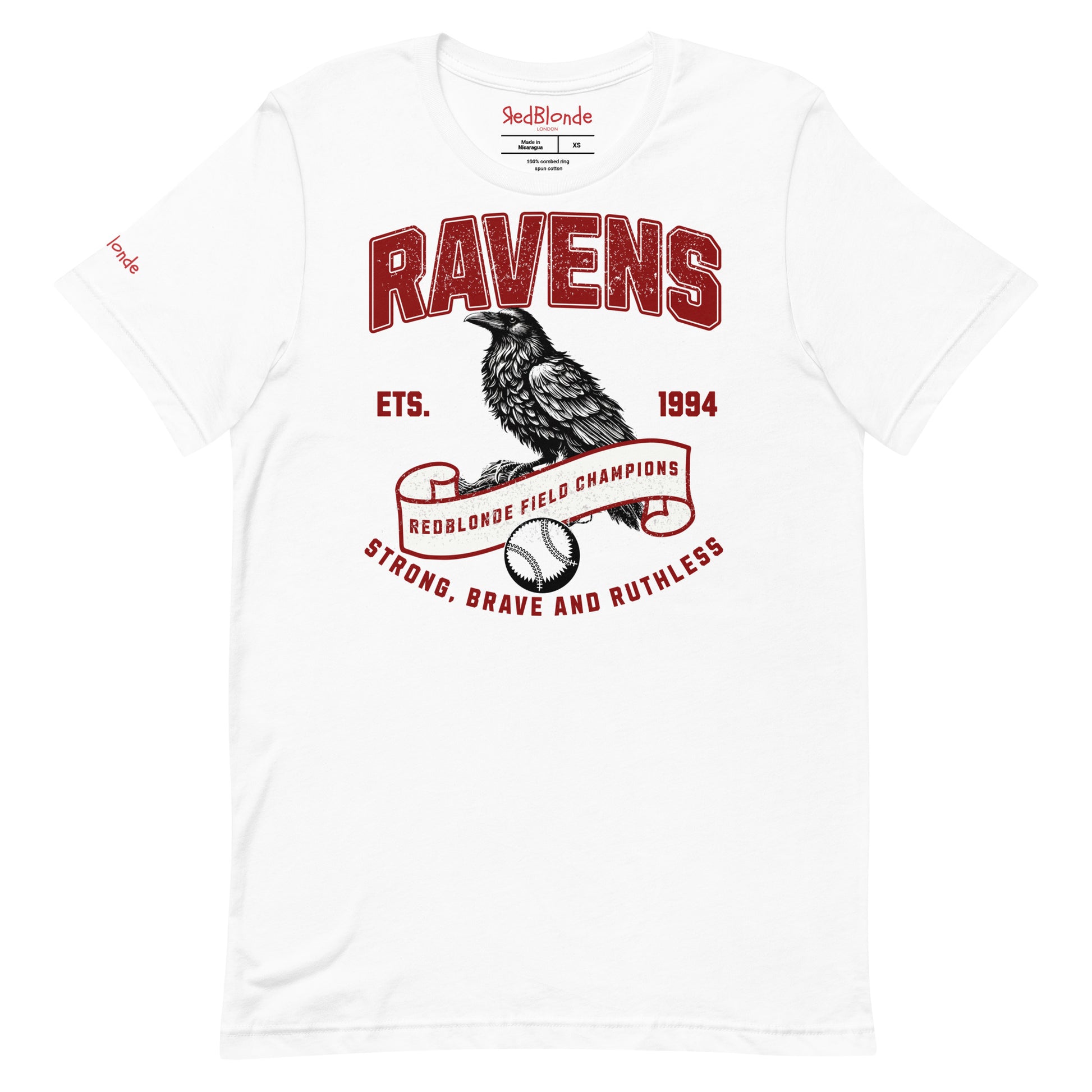 white unisex t-shirt featuring a bold american collegiate vintage-style graphic with the word "RAVENS" in distressed red lettering. Below, a detailed black raven illustration perches on a scroll that reads "REDBLONDE FIELD CHAMPIONS," with a baseball beneath it. Additional text includes "ETS. 1994" and the phrase "STRONG, BRAVE AND RUTHLESS" in red. RedBlonde branding appears on the inner neck label and left sleeve in red text.