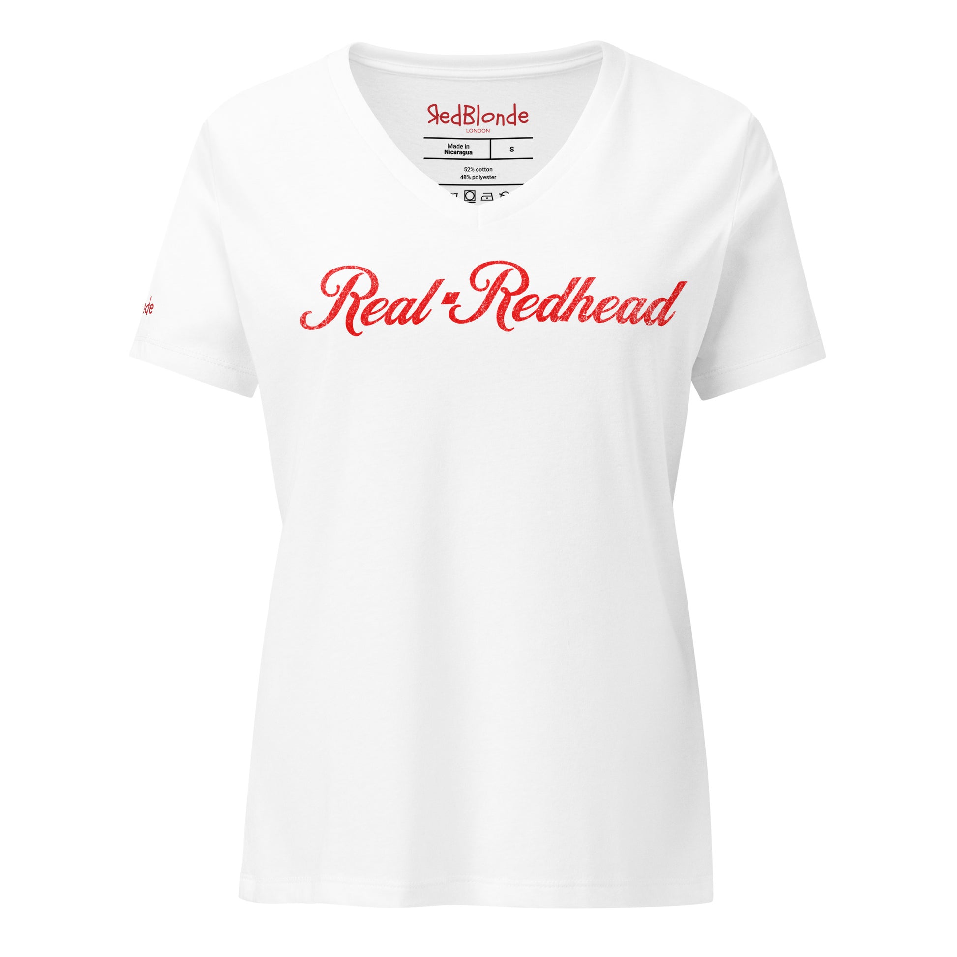 Flatlay of white women's relaxed fit v-neck slogan t-shirt with 'Real Redhead' in milkshake script red font. Branded RedBlonde in red on inside neck and right sleeve